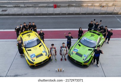 Shanghai, China- June 26,2022: A Group Of Mechanics And Two Drivers Are Standing By Two Mercedes-AMG GT3 EVO Sportcars