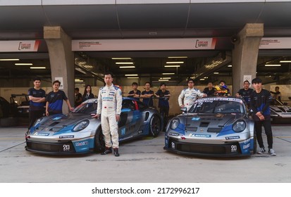 Shanghai, China- June 26,2022: A Group Of Mechanics And Two Driver Are Standing By Two Porsche 992 GT3 Cup Sportcars In Courtyard