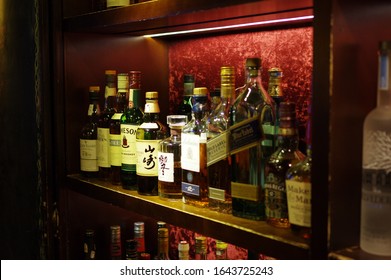 Shanghai, China - Oct 22, 2015: Various Brand Whisky Bottles On Old Wood Shelf In Vintage Bar