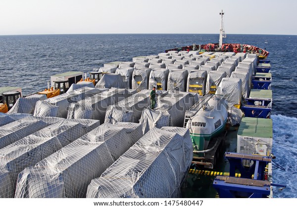 Shanghai, China, October 24, 2008.\
Loading heavy equipment and trucks aboard a Ro-Ro vessel in the\
port of Shanghai. Cargo securing and\
transportation.