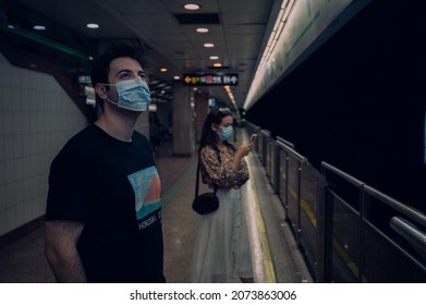 Shanghai China. October 3, 2021. Two Young People Man And Woman Wearing Protective Facial Masks In Local Subway Metropolitan Waiting For Train. Preventions During Coronavirus Outbreak Public Transport