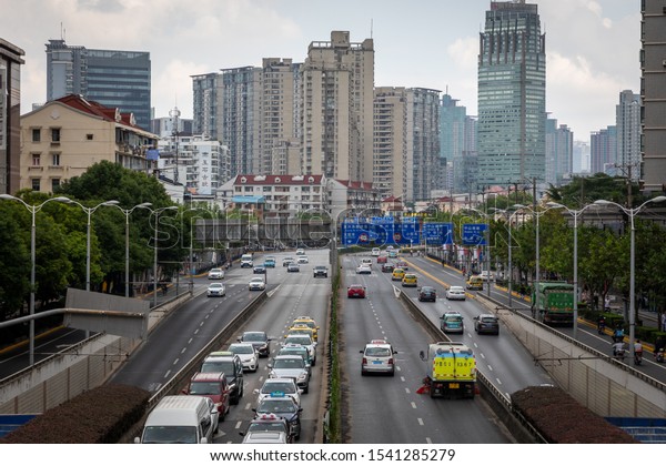 Shanghai, China -\
Octobre 13, 2019; Picture taken from footbridge on crossing Henan S\
road and Fuxing E Road view direction East traffic with cars\
scooters bikes buses\
trucks