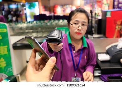 SHANGHAI CHINA-September 26, 2018: customers shop in a shopping mall using Alipay mobile wallet, WeChat payment and supermarket sweep code gun. becomes very common and popular in China,fast and safe.