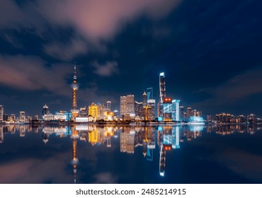 Shanghai cityscape reflection at night on the Bund - Powered by Shutterstock