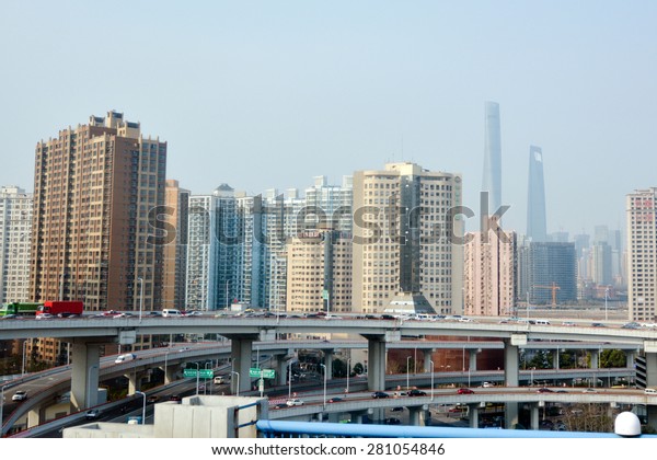 SHANGHAI, CN - MAR 15 2015:Traffic against\
Shanghai cityscape.Shanghai is the largest Chinese city by\
population and the largest city proper by population in the world\
with over 2 million\
vehicles.