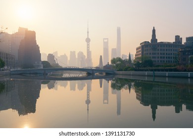 Shanghai Downtown Skyline By Huangpu River With Fog, China. Financial District And Business Centers In Smart City In Asia. Skyscraper And High-rise Buildings Near The Bund At Sunrise.