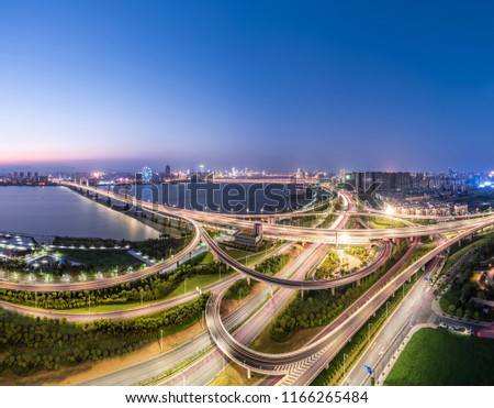 shanghai interchange overpass and elevated road in nightfall， skyline and traffic,flyover in modern city. 
