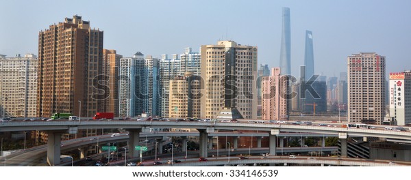 SHANGHAI- MAR 15 2015:Traffic against Shanghai\
skyline, China.Shanghai is the largest Chinese city by population\
and the largest city proper by population in the world with over 2\
million vehicles.