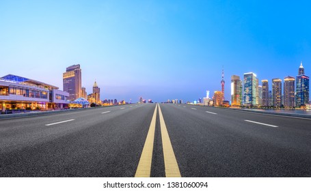 Shanghai Modern Commercial Office Buildings And Straight Asphalt Road At Night,panoramic View