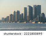 shanghai skyline in the morning, showing the Huangpu river with passing cargo ships, financial district buildings and cloudy sky background