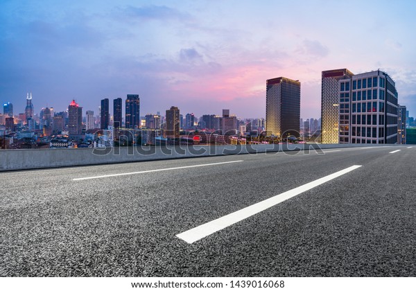 Shanghai skyline panoramic view with asphalt\
highway at sunset