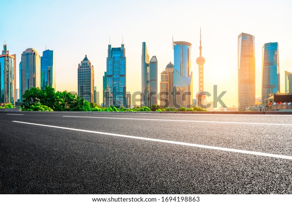 Shanghai urban architecture landscape and empty\
asphalt road in summer\
sunrise
