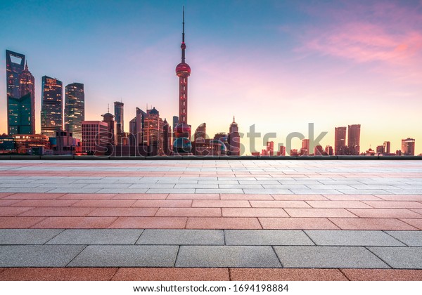 Shanghai urban architecture landscape and empty\
square road in summer\
sunrise