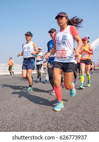 SHANGHAI,CHINA - April 23, 2017: Visually Impaired Marathon Runner And His Guide Running On City Road  At 2017 Shanghai International Half Marathon.