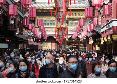 Shanghai.China-Feb.2021: crowded tourists in face mask to prevent coronavirus, at City God Temple during traditional Chinese new year
