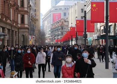 Shanghai.China-Feb.2021: crowded tourists in face mask to prevent coronavirus, walking on Nanjing Road