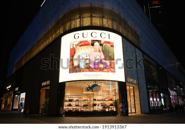 Shanghai.China-Feb.2021: Facade of GUCCI flagship store\
at night. Doraemon joint GUCCI sign. An Italian luxury brand of\
fashion\
