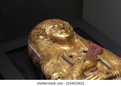 Shanghai,China-Feb.27th 2022: Close Up Golden Egyptian Mummy Of A Girl. Antique Authentic Mummy. Gilded Plaster And Linen.