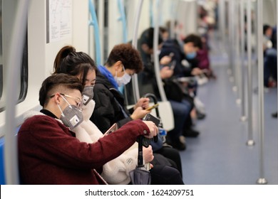 Shanghai,China-Jan.2020: coronavirus COVID-19 pneumonia has been spreading into many cities in China. People wearing surgical mask sitting in subway in Shanghai
