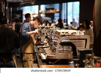 Shanghai/China-May 2020: Clerk Wearing Face Mask To Avoid Covid-19 Coronavirus, Working In Coffee Shop 