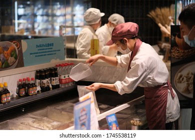 Shanghai/China-May 2020: Grocery Clerk Helping Customer To Pack Food, Wearing Face Mask To Avoid Covid-19 Coronavirus