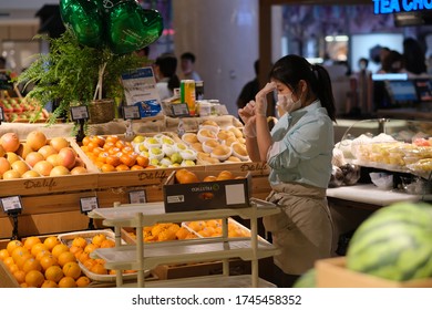 Shanghai/China-May 2020: One Working Fruit Store Clerk, Wearing Face Mask And Gloves To Avoid Covid-19 Coronavirus