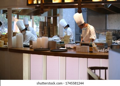 Shanghai/China-May 2020: Several Working Chef In Chinese Restaurant, Wearing Face Mask To Avoid Covid-19 Coronavirus