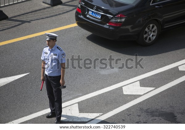 Shanghai,China-September 26,2015:Traffic\
police were directing traffic in the Lujiazui street where is the\
finance center area of\
Shanghai,China