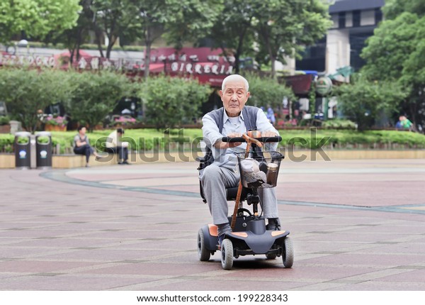 SHANGHAI-JUNE 4, 2014. Chinese elderly in an\
electric mini car. The population of the elderly (60 or older) in\
China is about 128 million or one in every ten people, which is the\
largest in the\
world.