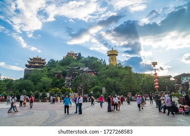 SHANGRILA,YUNNAN,CHINA-AUGUST 12,2019 : Many people in front of Guishan temple with giant buddhist tibetan prayer golden wheel in Dukezong ancient town