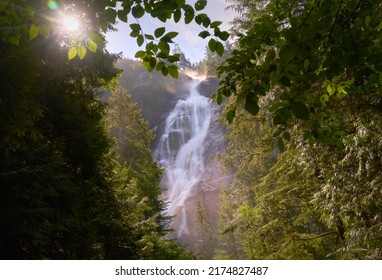 Shannon Falls Sunburst Squamish BC. Thundering Shannon Falls and the sun bursting through the trees. Located near Squamish north of Vancouver. British Columbia, Canada. 
 
                            