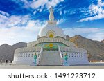 Shanti Stupa, Buddhist white-domed stupa on a hilltop in Chanspa, Leh, Ladakh in the north India. Nature background with blue sky, clouds. Travel Ladakh, India.