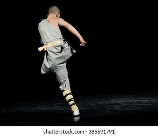 Shaolin monk jumps during the performance of Kung Fu