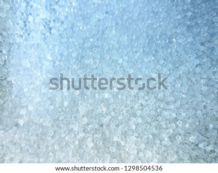 The shape of the absorbent material is circular.