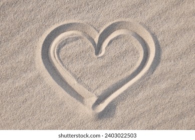 Shape of heart drawn on the sand, close up. Concept of love, passionate feelings, positive emotions, being in love - Powered by Shutterstock