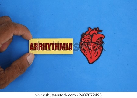 the shape of the heart organ with the word arrhythmia. heart disease