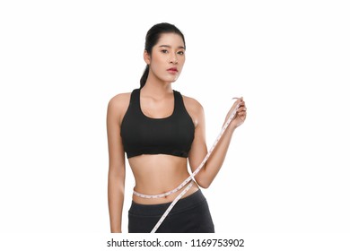 Shapely girl In a series of exercises now measure around her waist isolated on white background.