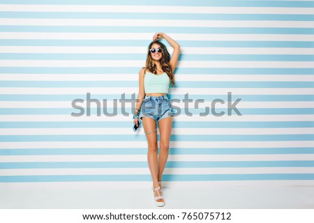 Similar – Surfer woman with top and bikini holding surfboard