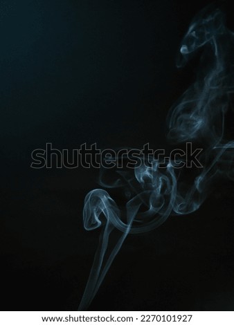 Shapes in motion- Smoke on a dark blue background