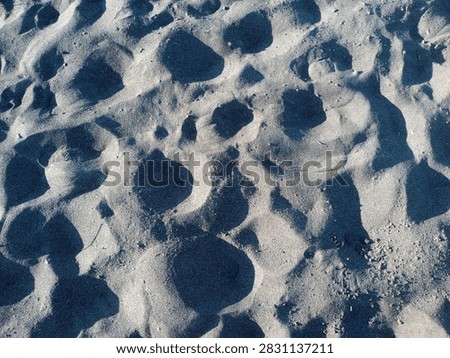 Shapes and patterns on sandy surface closeup image of the rive sand texture sunset peaceful afternoon 