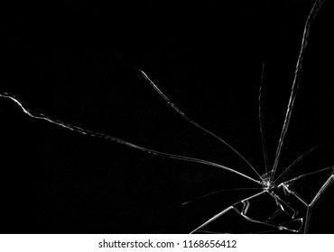 Shards of a broken glass on a black background, shattered pieces. Useful texture in overlay mode. Horizontal shot.

