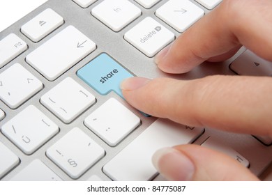 Share concept - computer keyboard with share keypad pressed by woman