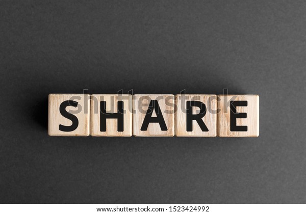 Share - word\
from wooden blocks with letters, to divide or use something with\
others share concept, gray\
background
