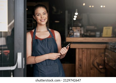 Share Your Passion For Coffee With Everyone Else. Portrait Of A Confident Young Woman Standing In The Doorway Of A Coffee Shop.