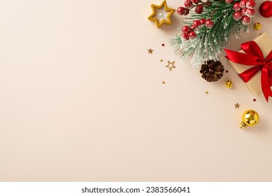 Share your warm wishes with this image idea. Top view of magnificent giftbox with red ribbon, sparkling ornaments, frosty fir, cone, holly berries, candle on light backdrop, ready for personalized ad