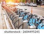 Share-use bicycles at a docking station along a street in downtown Chicago after a thunderstorm