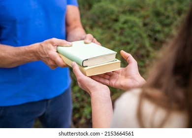 Sharing Books. Hand Closeup Giving Book Outdoors - Shutterstock ID 2153664561