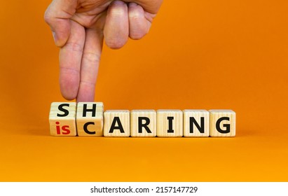 Sharing is caring symbol. Businessman turns wooden cubes with words 'sharing is caring'. Beautiful orange table, orange background. Business, sharing is caring concept. Copy space. - Shutterstock ID 2157147729