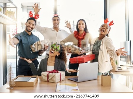 Sharing the Christmas spirit. Shot of a group of businesspeople celebrating during a Christmas party at work.