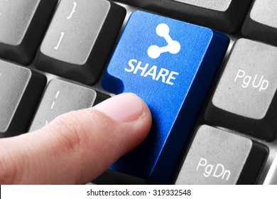 Sharing file. gesture of finger pressing share button on a computer keyboard